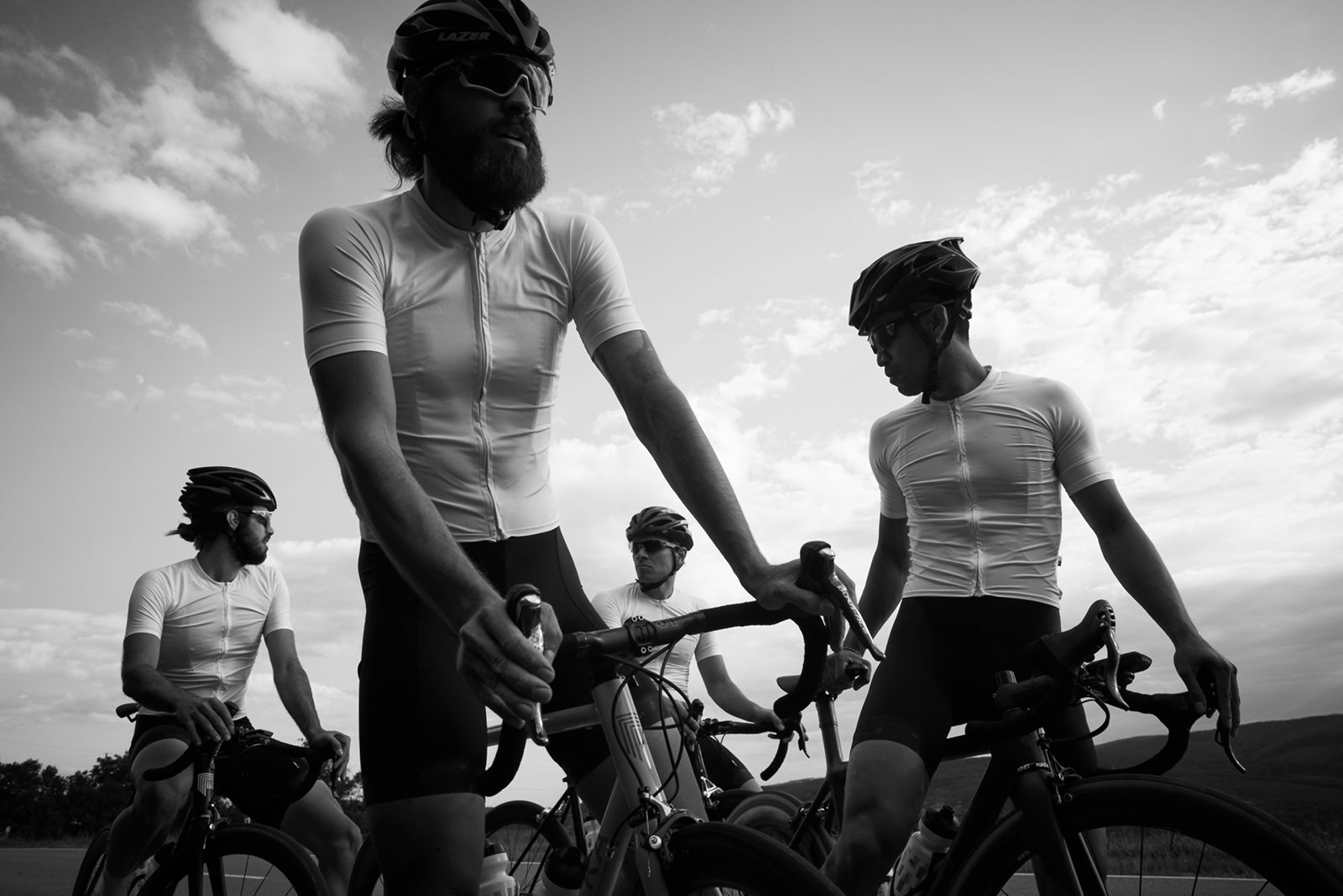 A club bunch standing with their bikes in matching MVMNT custom kit