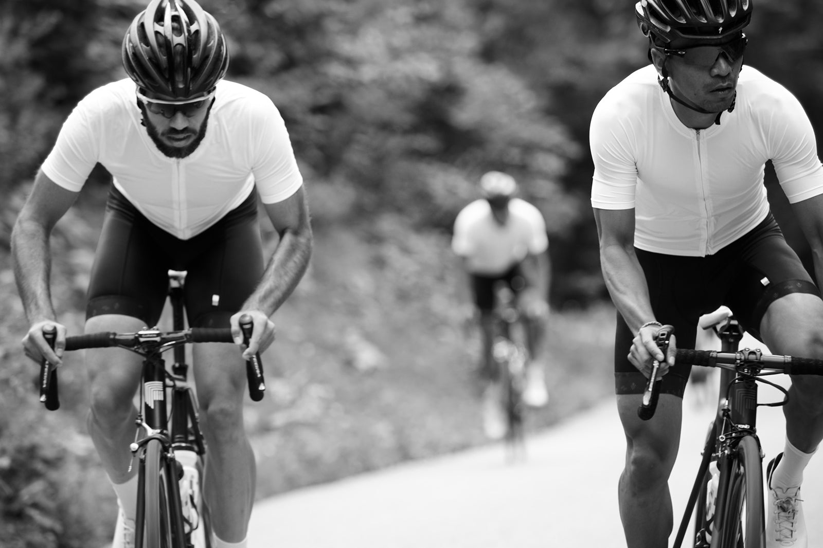 Two riders climbing in MVMNT custom club kit